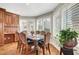 Dining area with a table, chairs, wood floors, and a large window at 5224 Painted Lakes Way, Las Vegas, NV 89149