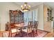 Charming dining area with classic furniture, hardwood floors, and seamless flow into the kitchen and living spaces at 5224 Painted Lakes Way, Las Vegas, NV 89149