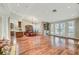 Elegant dining area featuring hardwood floors, stylish chandelier, and large windows overlooking the lush backyard at 5224 Painted Lakes Way, Las Vegas, NV 89149