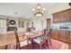 Dining area featuring hardwood floors, custom built-ins, and seamless transition to the adjacent living area with fireplace at 5224 Painted Lakes Way, Las Vegas, NV 89149