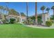 Charming single-story home featuring a tile roof, manicured lawn, and mature palm trees in a desirable neighborhood at 5224 Painted Lakes Way, Las Vegas, NV 89149