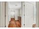 Bright hallway featuring hardwood floors, white doors, and natural light from windows at 5224 Painted Lakes Way, Las Vegas, NV 89149