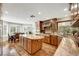 Bright kitchen with an island, wood cabinets, granite countertops, and stainless steel appliances at 5224 Painted Lakes Way, Las Vegas, NV 89149