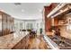 Large kitchen featuring wood cabinets, stainless steel appliances, and an island with granite countertops at 5224 Painted Lakes Way, Las Vegas, NV 89149