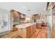 Well appointed kitchen featuring wood cabinets, stainless steel appliances, and an island at 5224 Painted Lakes Way, Las Vegas, NV 89149