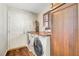 Well-lit laundry area featuring a washer, dryer, wood counters, and custom cabinets at 5224 Painted Lakes Way, Las Vegas, NV 89149