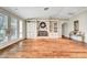 Spacious living area featuring hardwood floors, custom built-ins, and a cozy fireplace with mantel at 5224 Painted Lakes Way, Las Vegas, NV 89149