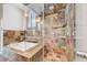 Updated shower features a glass surround, multiple shower heads, and stone-tiled walls at 5224 Painted Lakes Way, Las Vegas, NV 89149