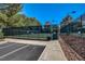 Well-maintained outdoor tennis court with secure fencing, landscaping and clear blue skies at 5224 Painted Lakes Way, Las Vegas, NV 89149