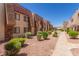Exterior view of apartment buildings with manicured landscaping and pathways at 5301 River Glen Dr # 205, Las Vegas, NV 89103