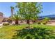 Green lawn, with palm trees and access to community tennis courts and swimming pool at 5301 River Glen Dr # 205, Las Vegas, NV 89103