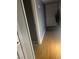 Bright hallway with hardwood floors leading to a white door and coat rack on the right at 5301 River Glen Dr # 205, Las Vegas, NV 89103