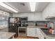 Well-lit kitchen with stainless steel appliances and stone countertops at 5301 River Glen Dr # 205, Las Vegas, NV 89103