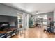 Bright living room features hardwood floors and access to the balcony at 5301 River Glen Dr # 205, Las Vegas, NV 89103
