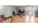 A spacious living room featuring wood floors and sliding glass doors with a patio at 5301 River Glen Dr # 205, Las Vegas, NV 89103