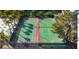 Aerial view of two community tennis courts lined with tall palm trees and meticulously kept landscaping at 5301 River Glen Dr # 205, Las Vegas, NV 89103