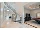Grand foyer showcasing curved staircase, decorative ceiling and travertine flooring at 5367 Secluded Brook Ct, Las Vegas, NV 89149