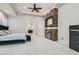 Bright primary bedroom features a statement stone fireplace wall and cozy sitting area at 5367 Secluded Brook Ct, Las Vegas, NV 89149