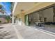 Covered patio area with dining set, ceiling fan and sliding glass doors to the interior living space at 5367 Secluded Brook Ct, Las Vegas, NV 89149
