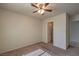 Carpeted bedroom with a ceiling fan and view into a bathroom with tile floor at 5425 Thomaston Ct, Las Vegas, NV 89122