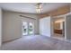 Large bedroom with sliding glass doors and view into the bathroom at 5425 Thomaston Ct, Las Vegas, NV 89122