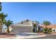 Inviting single-story home with a two-car garage, desert landscaping, and a classic tile roof at 5425 Thomaston Ct, Las Vegas, NV 89122