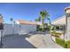 Beautifully landscaped home featuring a mature palm tree and well-maintained yard at 5425 Thomaston Ct, Las Vegas, NV 89122