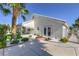 Exterior view of home showcases lush landscaping and a charming covered patio at 5425 Thomaston Ct, Las Vegas, NV 89122