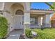 Welcoming front entrance with stone accents, manicured bushes, and a secure screen door at 5425 Thomaston Ct, Las Vegas, NV 89122