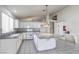 Bright kitchen featuring a large island, white cabinetry, and tile backsplash at 5425 Thomaston Ct, Las Vegas, NV 89122