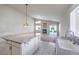 An open kitchen boasts an island and overlooks a living area with fireplace and backyard access at 5425 Thomaston Ct, Las Vegas, NV 89122