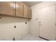 Functional laundry room with upper cabinets and tile floors at 5425 Thomaston Ct, Las Vegas, NV 89122