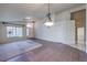 Bright living room with a blend of carpet and tile flooring, with adjacent hallway and entryway at 5425 Thomaston Ct, Las Vegas, NV 89122
