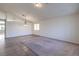 Spacious living room with tile and carpet flooring, bright lighting, and neutral walls at 5425 Thomaston Ct, Las Vegas, NV 89122