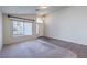 Open living space with neutral walls, combination tile/carpet flooring, and a window view at 5425 Thomaston Ct, Las Vegas, NV 89122