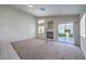 Spacious living room with a fireplace and sliding glass doors leading to the backyard at 5425 Thomaston Ct, Las Vegas, NV 89122