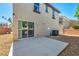 View of the backyard with patio, rock landscaping, and privacy block wall at 582 Brompton St, Las Vegas, NV 89178
