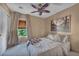 Cozy bedroom with a patterned ceiling fan, neutral walls, and a comfortable bed at 582 Brompton St, Las Vegas, NV 89178