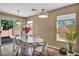 Dining room features a sleek white table, stylish chairs, and a sliding door to the yard at 582 Brompton St, Las Vegas, NV 89178