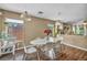 Inviting dining area with a modern table, seating for six, and sliding glass doors at 582 Brompton St, Las Vegas, NV 89178