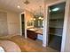 Bright bathroom featuring a vanity with granite counters and walk-in closet at 585 Via Alhambra, Las Vegas, NV 89123