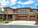 Two-story home with a three-car garage, desert landscaping, and a red-tiled roof at 585 Via Alhambra, Las Vegas, NV 89123
