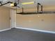 Attached garage featuring epoxy flooring, installed storage racks, and an automatic garage door opener at 585 Via Alhambra, Las Vegas, NV 89123
