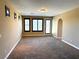 Open living space with carpet flooring, recessed lighting and an arched doorway at 585 Via Alhambra, Las Vegas, NV 89123
