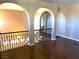 Loft area showcasing hardwood floors, arched entryways, and wrought iron railings at 585 Via Alhambra, Las Vegas, NV 89123