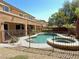 Backyard swimming pool and spa enclosed by an iron fence and surrounded by landscaping at 585 Via Alhambra, Las Vegas, NV 89123
