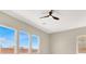 Well-lit bedroom with multiple windows and a modern ceiling fan at 5908 Big Horn View St, North Las Vegas, NV 89031