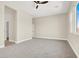 Large, carpeted bedroom with a ceiling fan and natural light from the windows at 5908 Big Horn View St, North Las Vegas, NV 89031