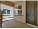 Covered front porch with stone pillar and a modern, dark-colored front door at 5908 Big Horn View St, North Las Vegas, NV 89031