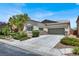Charming single-story home with a well-manicured front yard and a three-car garage at 5908 Big Horn View St, North Las Vegas, NV 89031